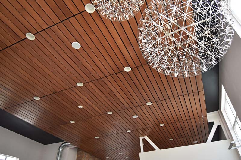 Image of a ceiling after being stained and varnished a dark brown colored finish.