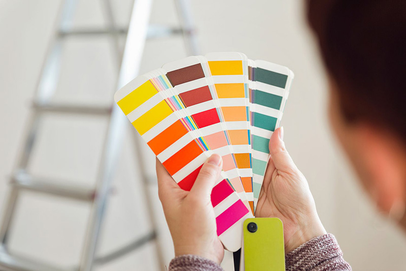 Image of a person holding a fan of color samples