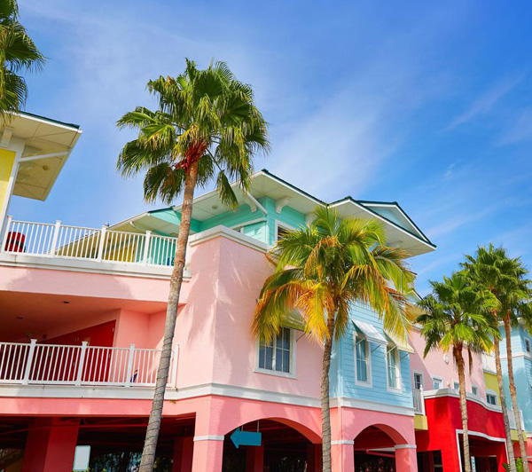 Sidewalk image of a downtown Naples business showing a fresh paint job of multiple colors and shades.