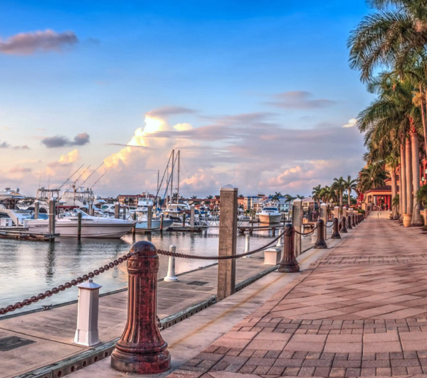 Ground level view of a marina mid-day showing boats and yachts at their moorings.
