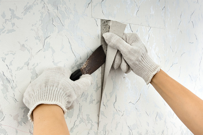 Image of someone removing old wallpaper